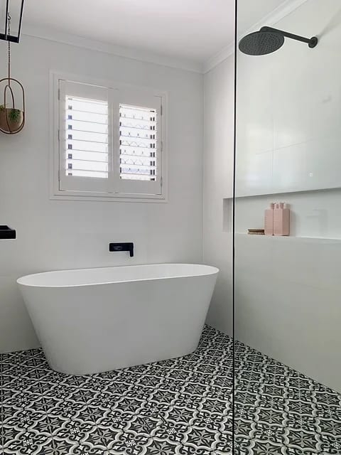 Bathroom with large-format wall tile, glass shower screen and a wall-hung vanity